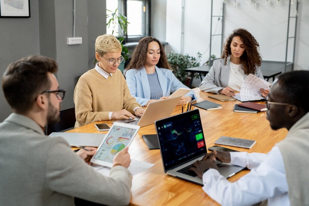 Large group of financier working individually by table in office