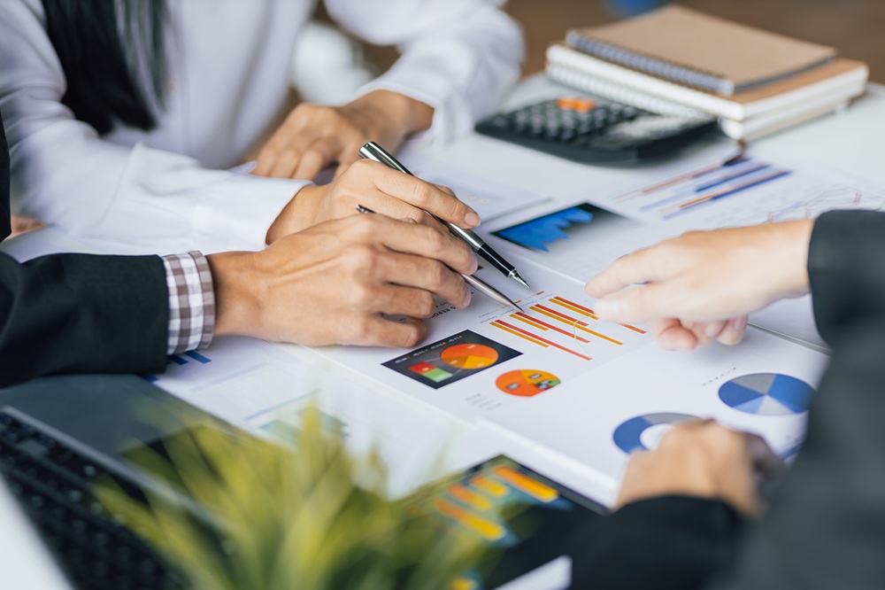 Business people meeting together brainstorming business strategy analysis and investment planning. Financial consultant discuss analysis financial chart and market growth graph for business planning.