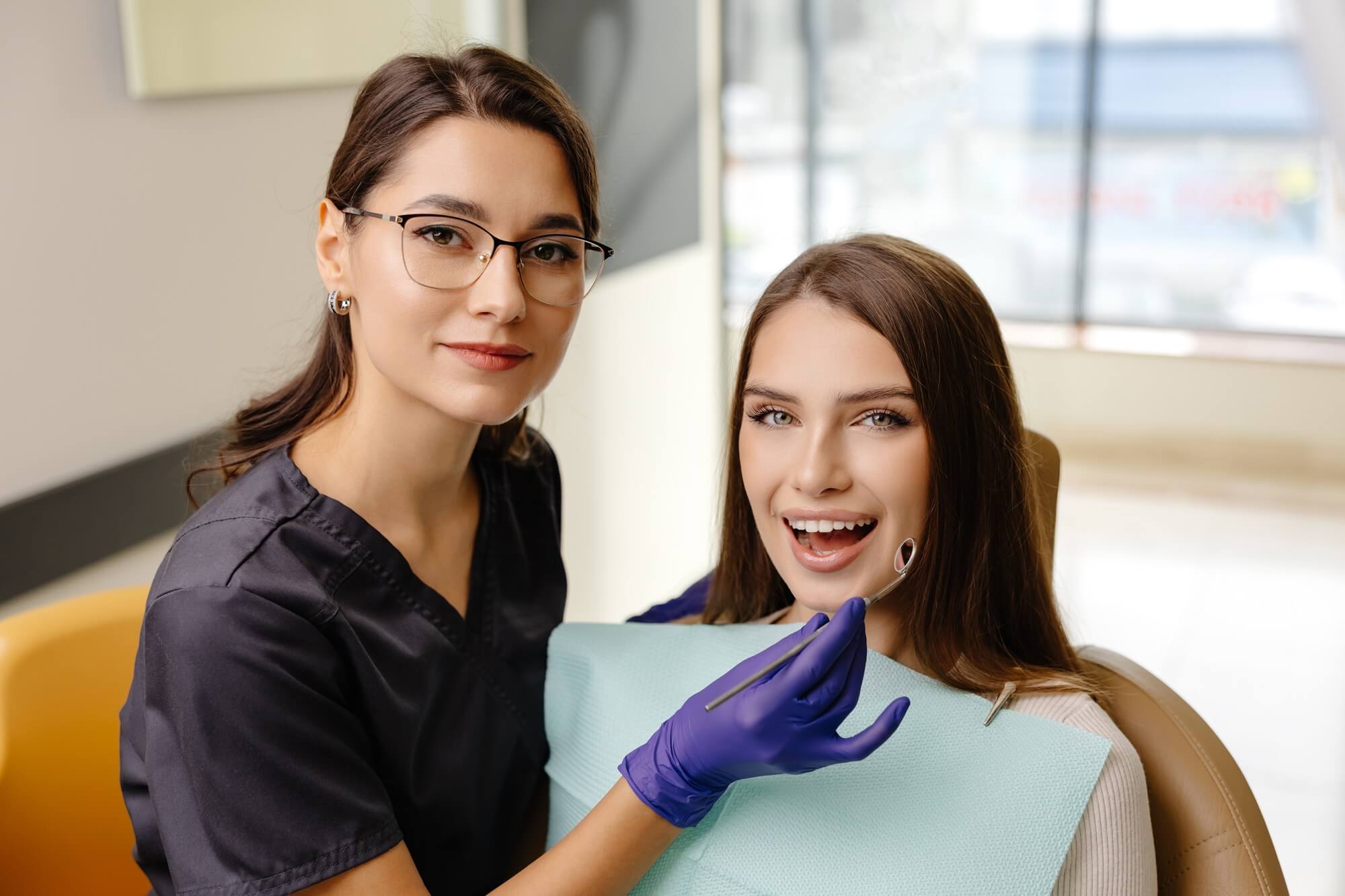 female-dentist-examines-patient-smiling-in-dental-2026-03-26-10-24-55-utc (1)