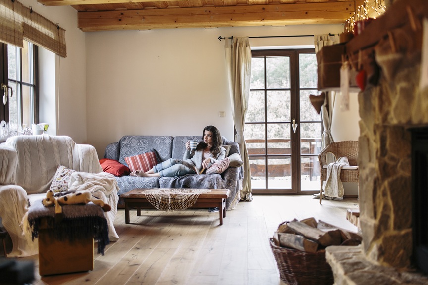 Young woman at home reading a book